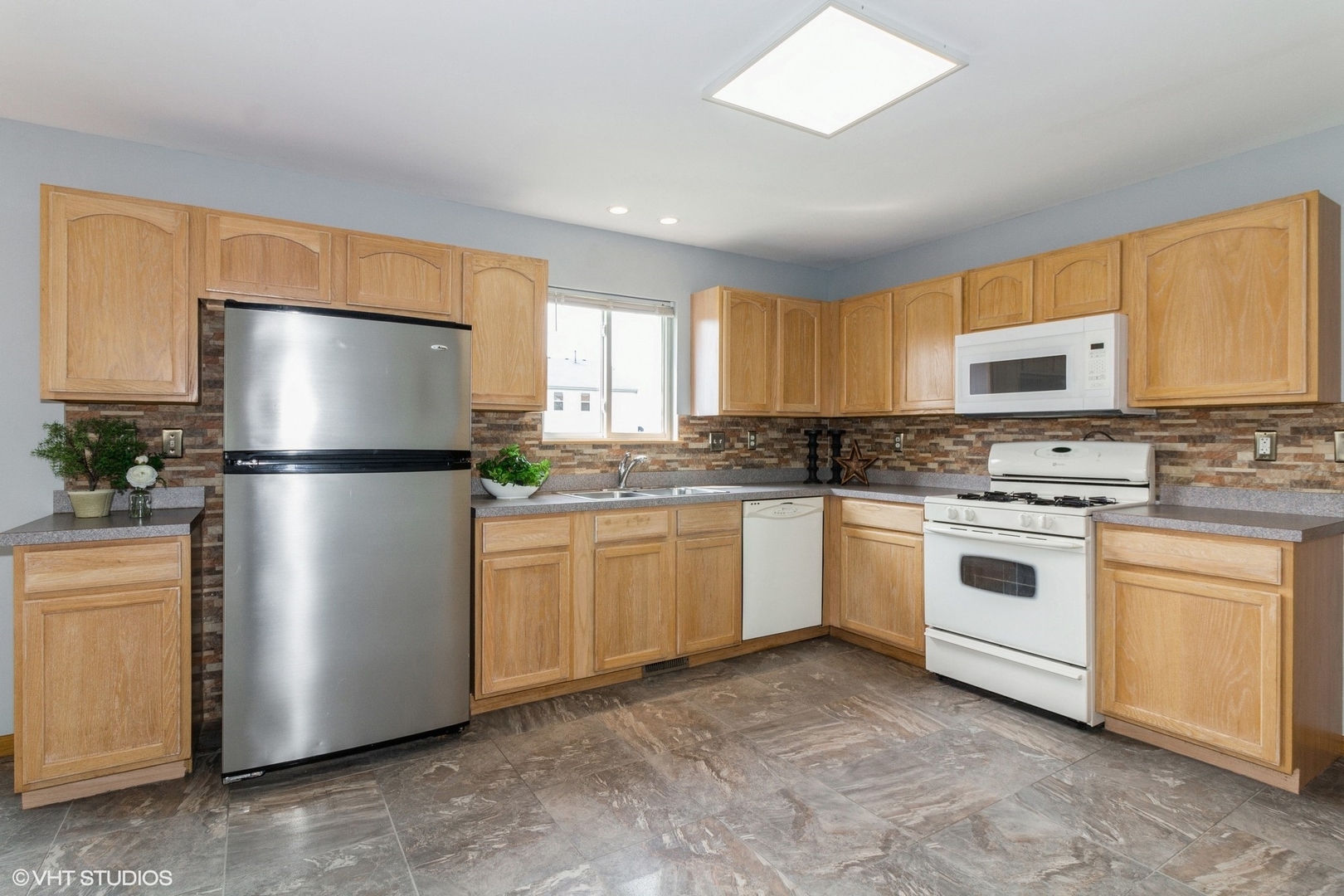 603 Kennedy Street Waterman, IL 60556 - Photo 8 of 25 a kitchen with stainless steel appliances granite countertop a refrigerator sink and cabinets