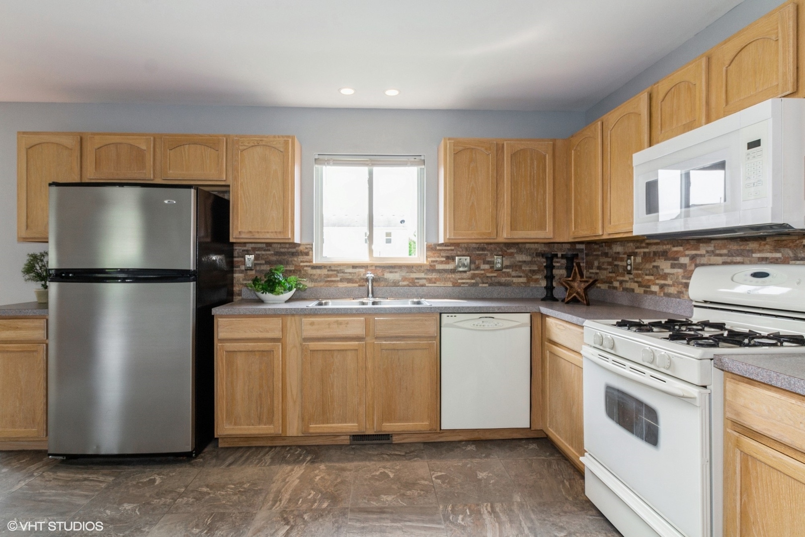 603 Kennedy Street Waterman, IL 60556 - Photo 9 of 25 a kitchen with a refrigerator sink stove and cabinets