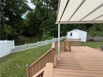 a view of a house with backyard and sitting area