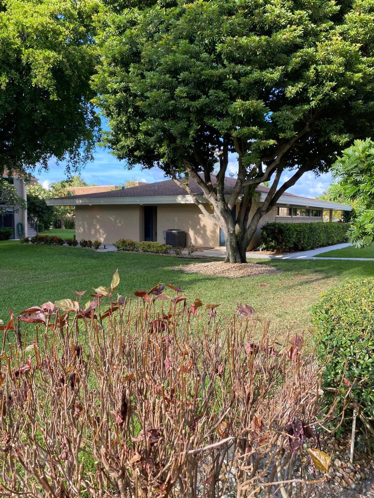 1271 Northwest 13th Street, Unit 361E Boca Raton, FL 33486 - Photo 18 of 19 a view of a house with a yard