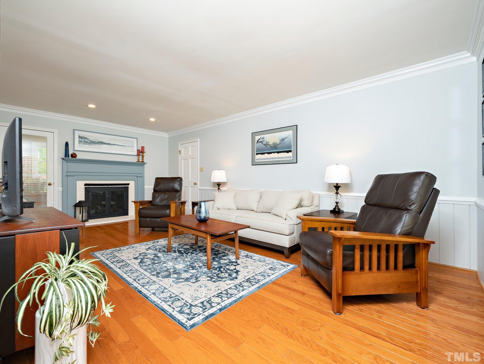 4508 Old Village Road Raleigh, NC 27612 - Photo 15 of 29 a living room with furniture and a fireplace