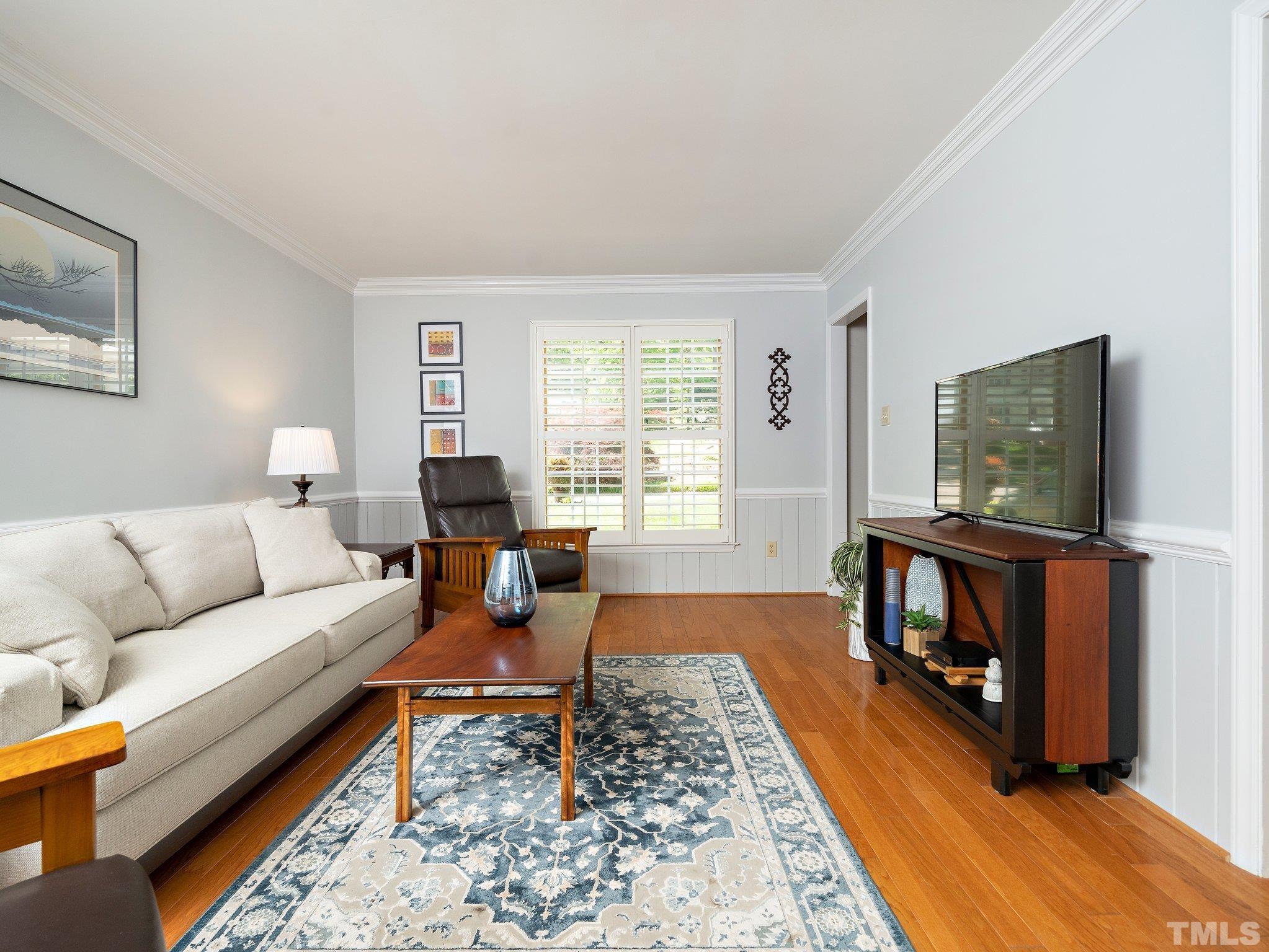 4508 Old Village Road Raleigh, NC 27612 - Photo 17 of 29 a living room with furniture and a flat screen tv