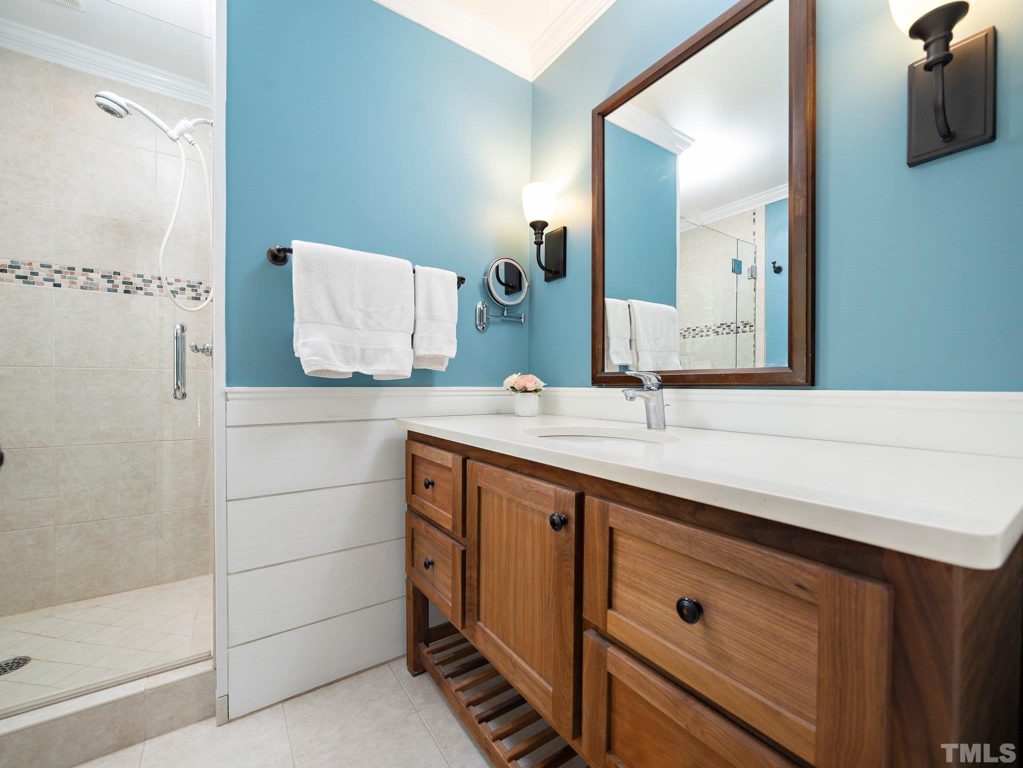 4508 Old Village Road Raleigh, NC 27612 - Photo 20 of 29 a bathroom with a double vanity sink and a mirror