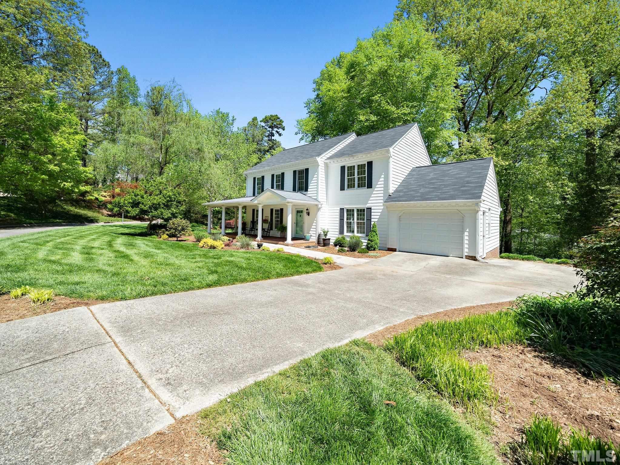 4508 Old Village Road Raleigh, NC 27612 - Photo 2 of 29 a front view of a house with a yard and garage