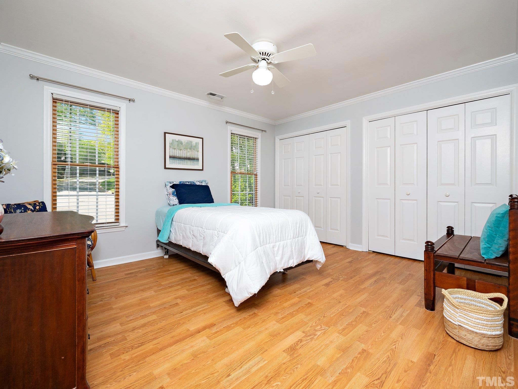 4508 Old Village Road Raleigh, NC 27612 - Photo 22 of 29 a bedroom with a bed and wooden floor