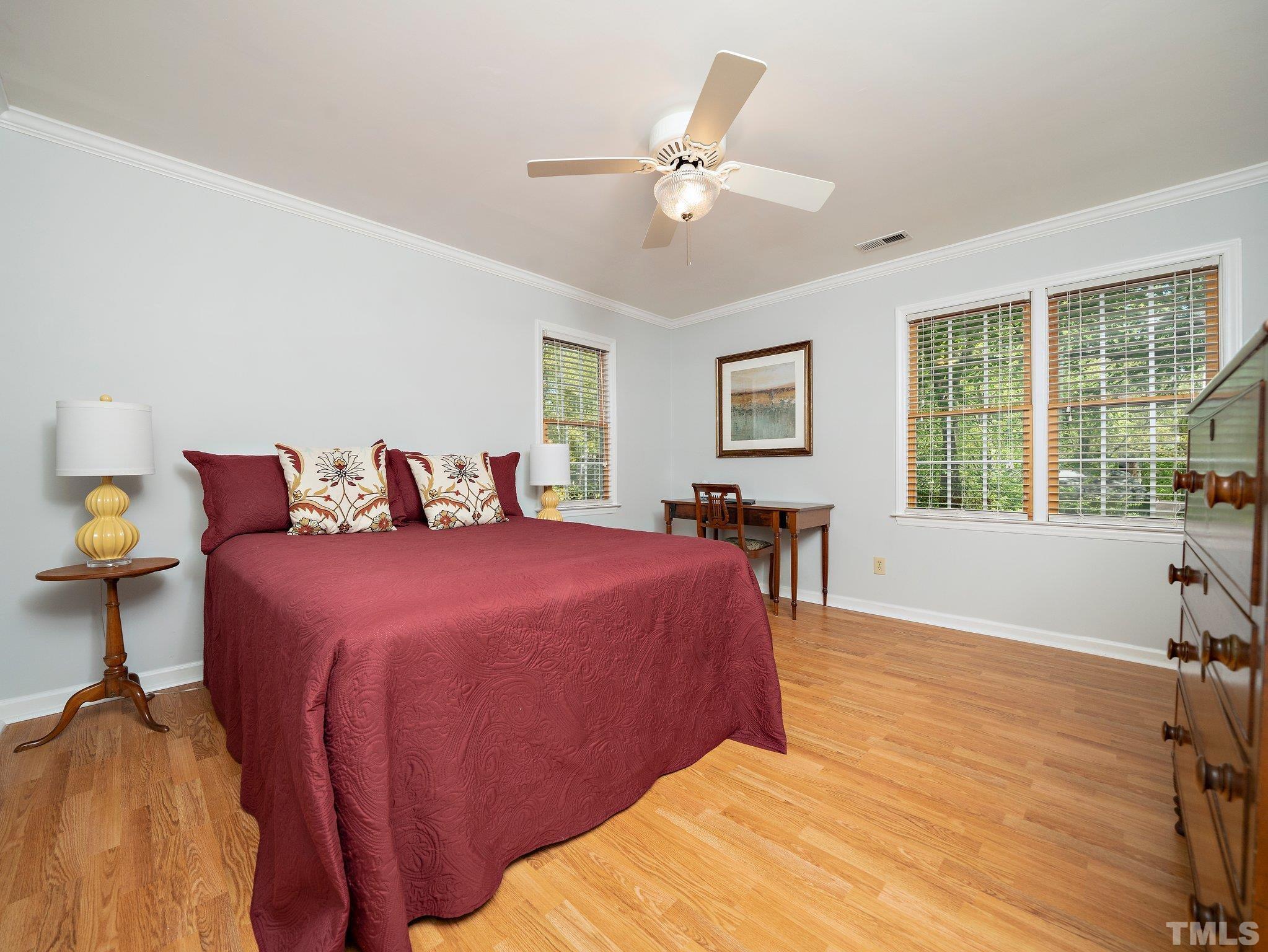 4508 Old Village Road Raleigh, NC 27612 - Photo 23 of 29 a bedroom with a large bed and a large window