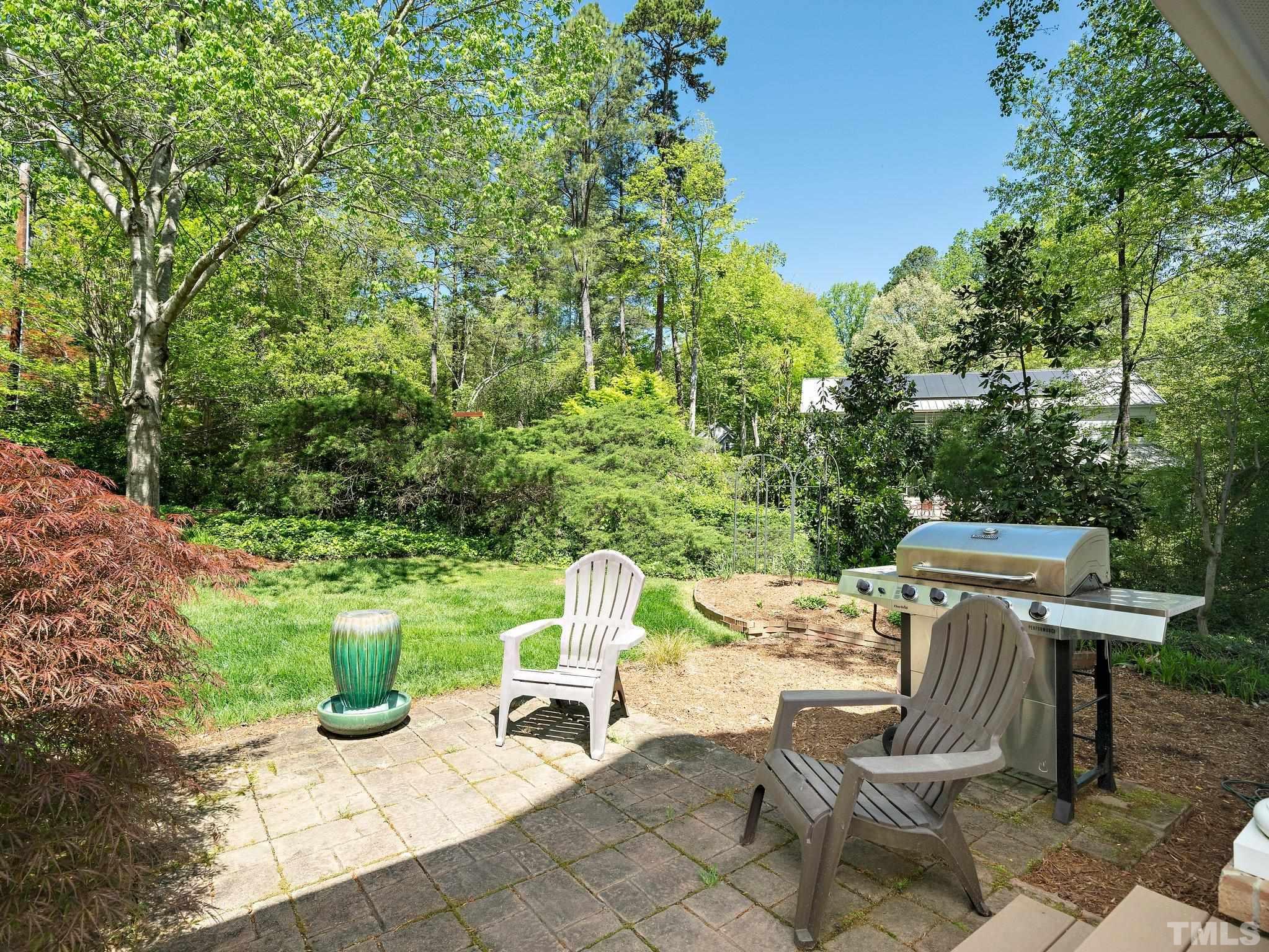 4508 Old Village Road Raleigh, NC 27612 - Photo 27 of 29 a view of a chairs and table in the back yard of the house