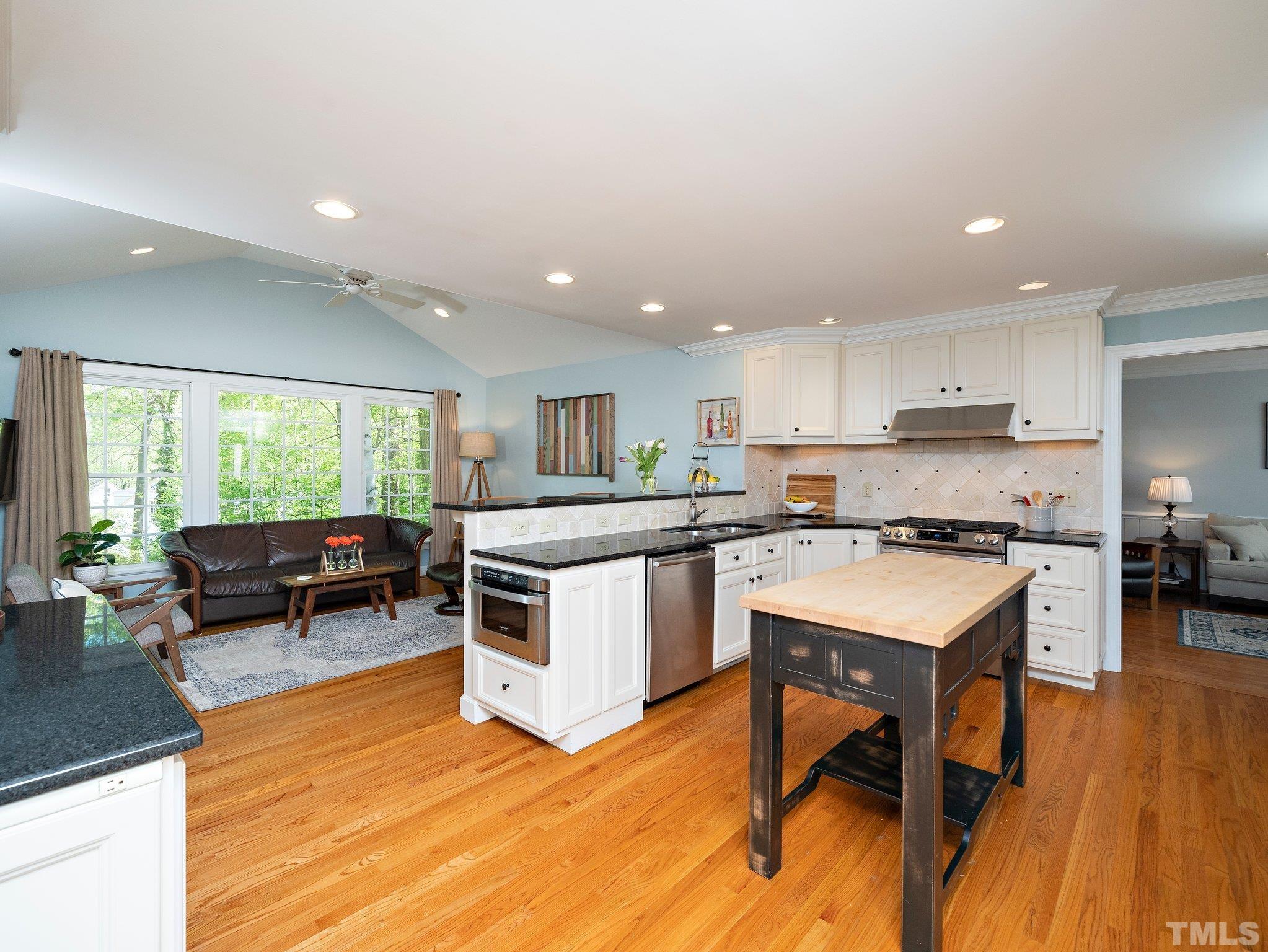 4508 Old Village Road Raleigh, NC 27612 - Photo 5 of 29 a kitchen with a sink cabinets and wooden floor