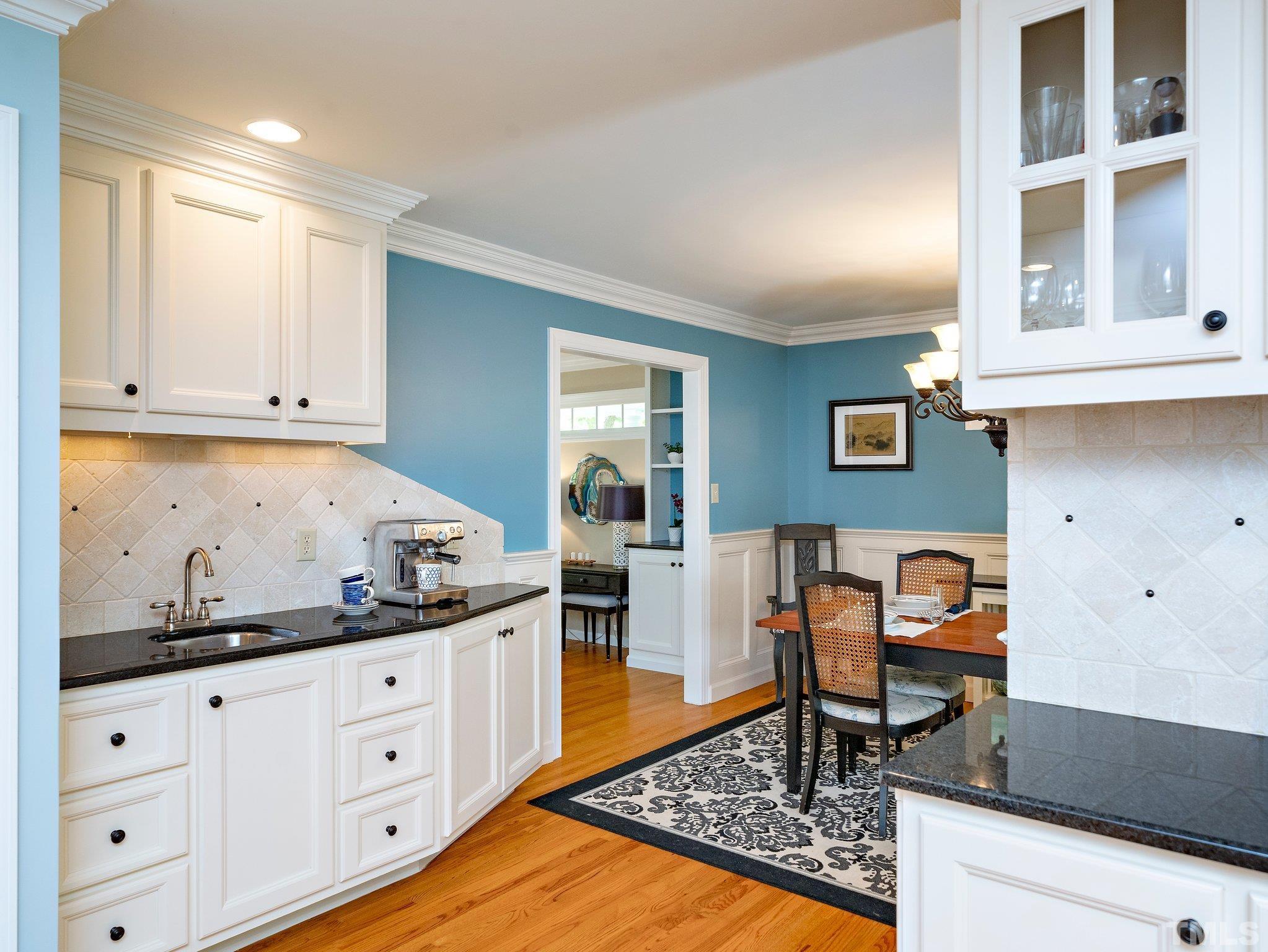 4508 Old Village Road Raleigh, NC 27612 - Photo 6 of 29 a kitchen with granite countertop white cabinets and white appliances