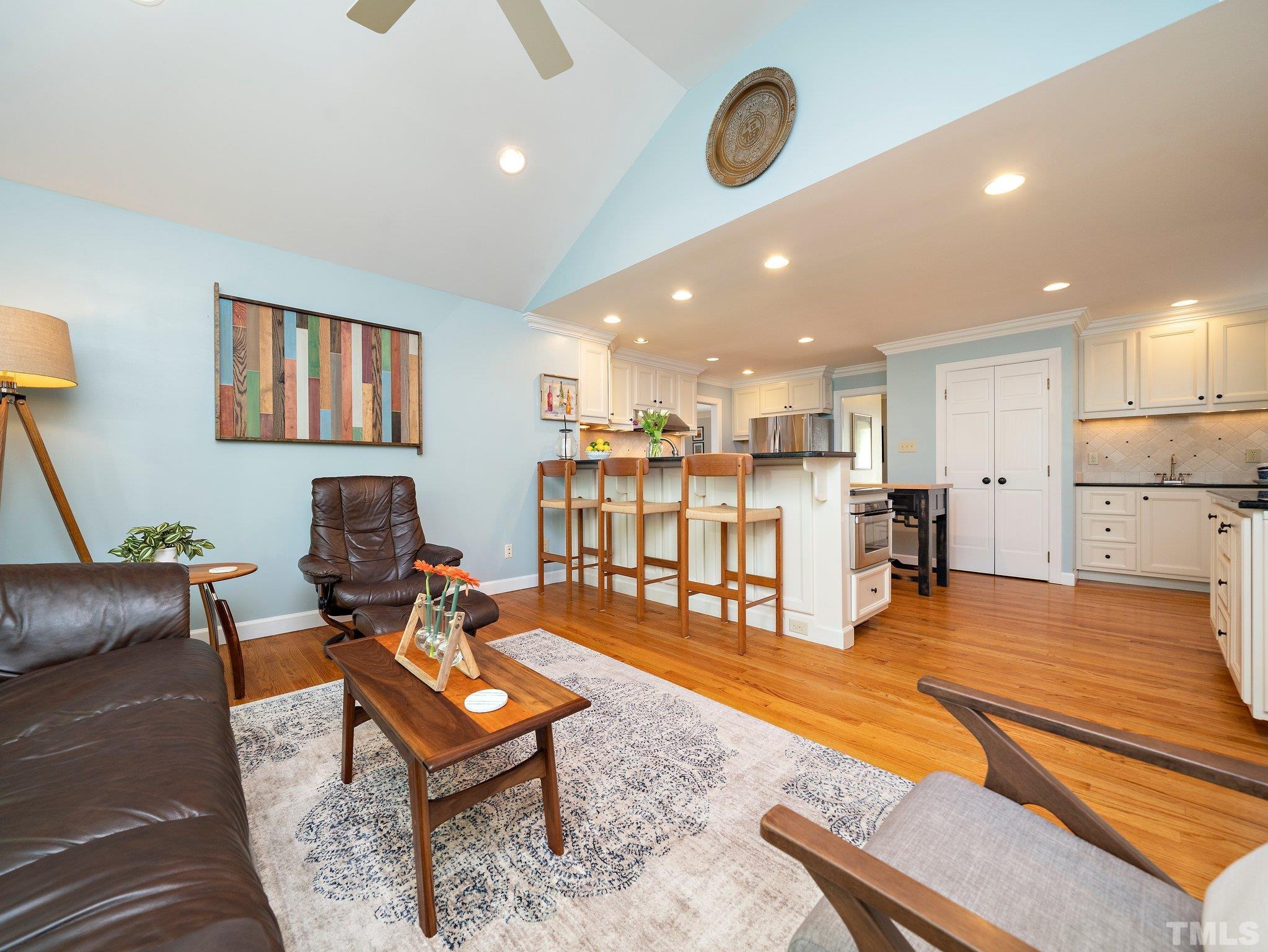 4508 Old Village Road Raleigh, NC 27612 - Photo 9 of 29 a living room with furniture kitchen view and a table