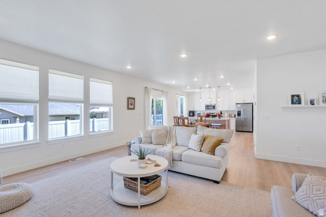 2664 West Maple Street Mapleton, UT 84664 - Photo 12 of 49 Spacious living area featuring light wood-finish flooring, recessed lighting, and multiple windows