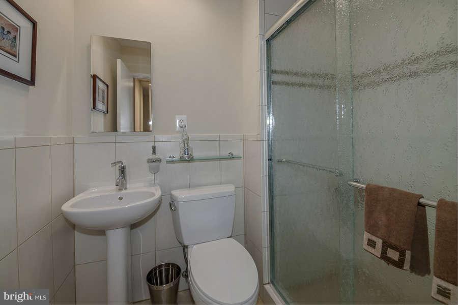 7906 Inverness Ridge Road Potomac, MD 20854 - Photo 17 of 30 a bathroom with a toilet sink and mirror