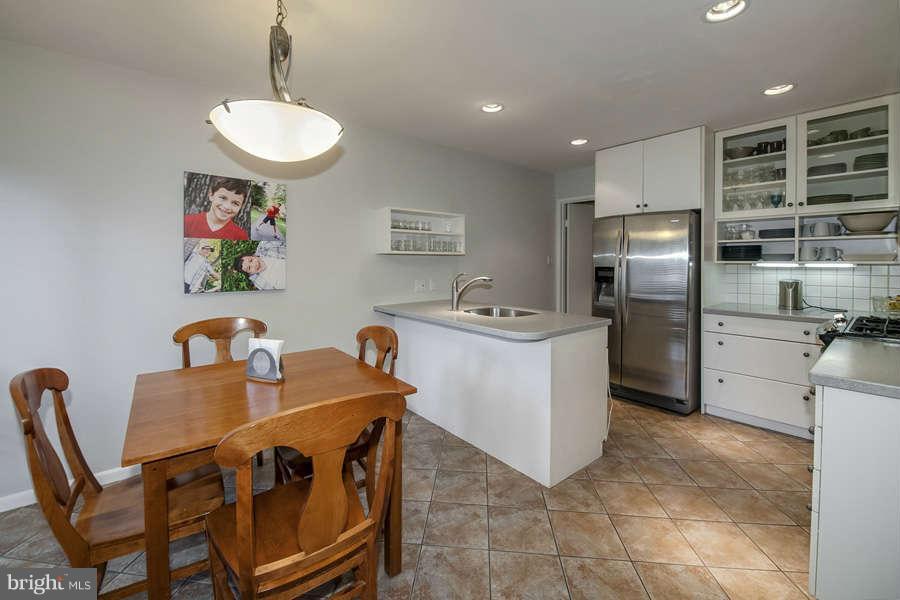 7906 Inverness Ridge Road Potomac, MD 20854 - Photo 5 of 30 a kitchen with stainless steel appliances granite countertop a sink a stove and a refrigerator