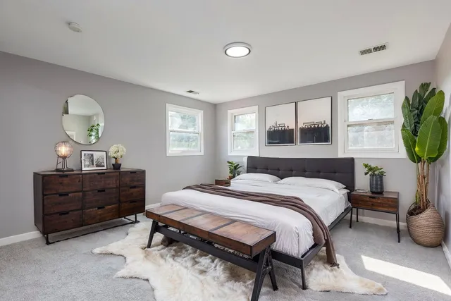 a bedroom with a bed and windows