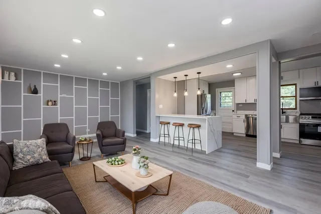 a living room with furniture and a wooden floor