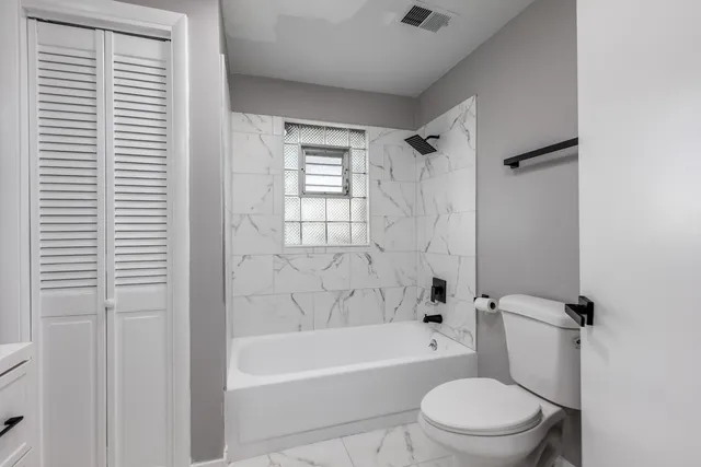 a bathroom with a toilet and a bathtub