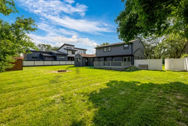 a swimming pool with outdoor seating and yard