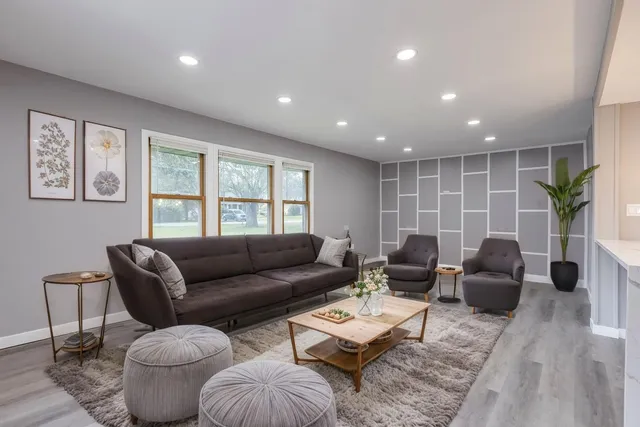 a living room with furniture and a large window