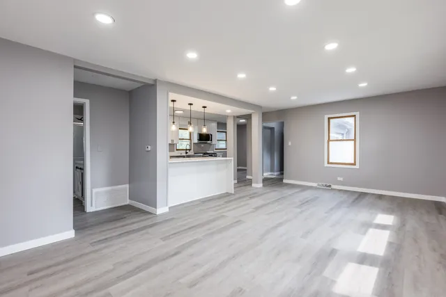 a view of empty room with wooden floor