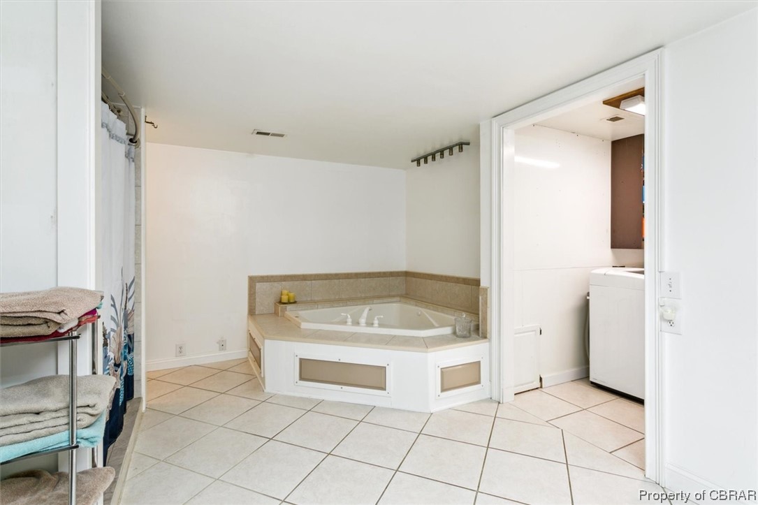 3255 Providence Road Hayes, VA 23072 - Photo 26 of 46 Bathroom featuring washer / dryer, tile flooring, and a bath