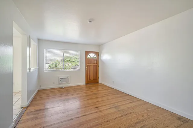 wooden floor in an empty room with a window