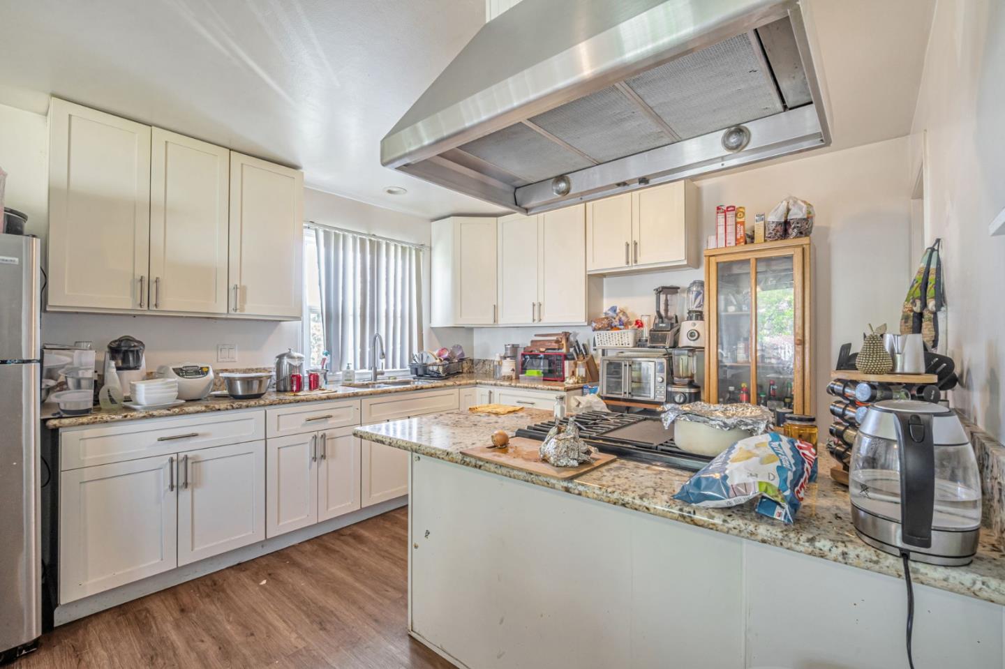 838 Wheeler Street Santa Rosa, CA 95404 - Photo 12 of 45 a view of a kitchen with kitchen island granite countertop a sink appliances cabinets and a counter top space