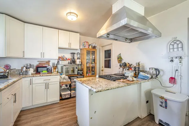 a kitchen with a sink stove and cabinets
