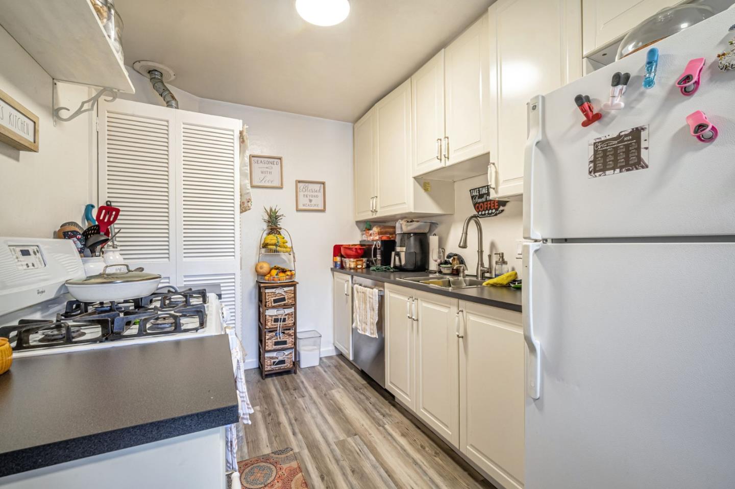838 Wheeler Street Santa Rosa, CA 95404 - Photo 14 of 45 a kitchen with stainless steel appliances a refrigerator and a stove top oven