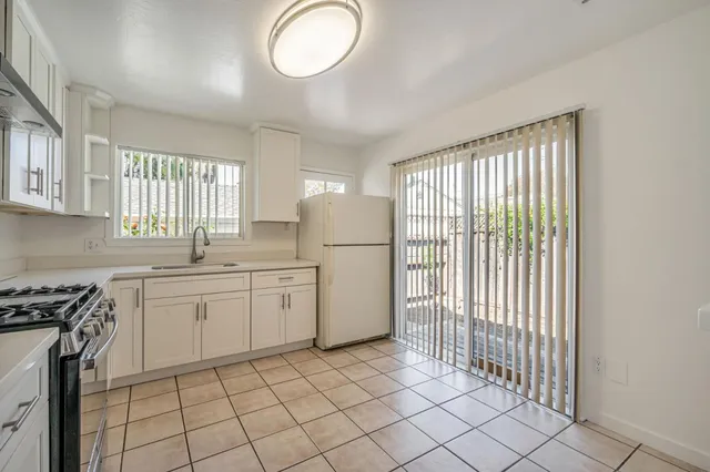 a kitchen with appliances cabinets and a sink