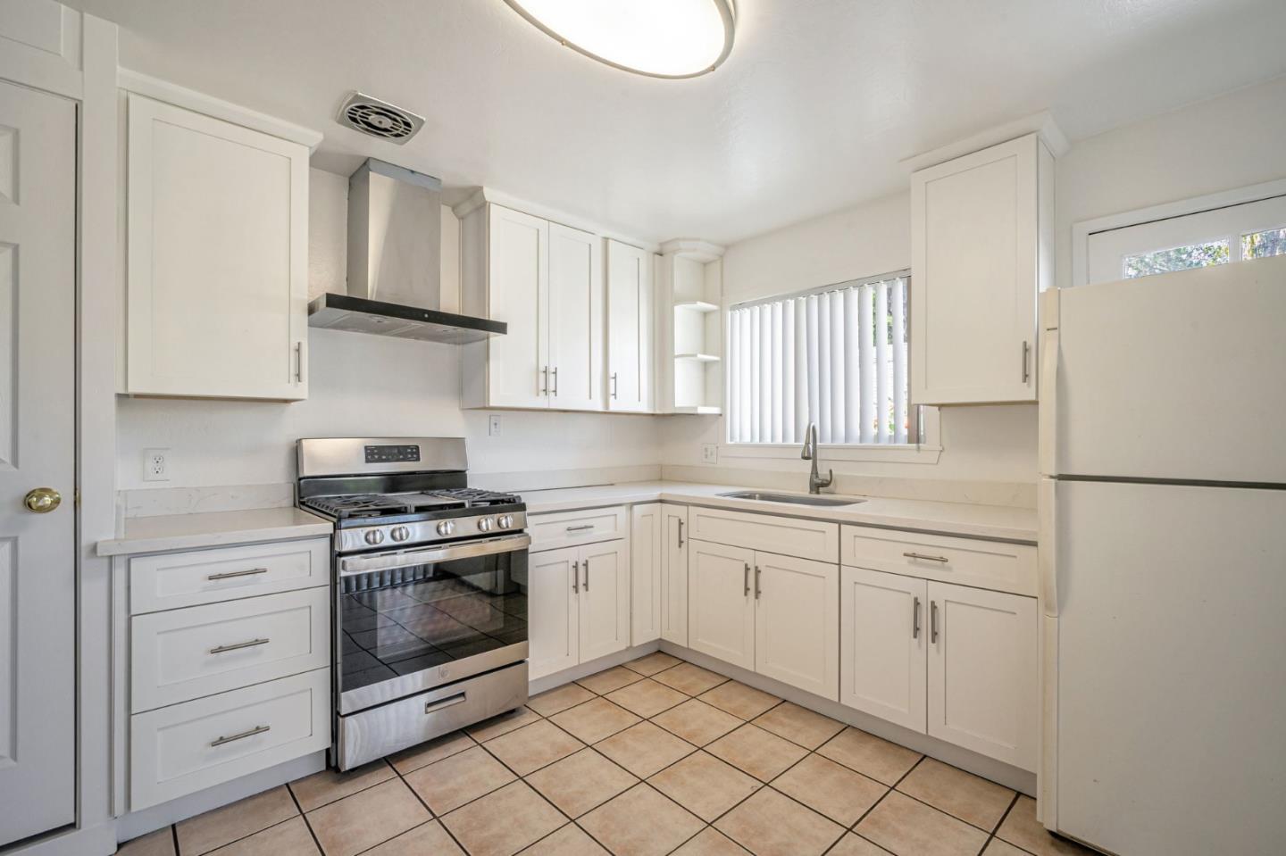 838 Wheeler Street Santa Rosa, CA 95404 - Photo 22 of 45 a kitchen with white cabinets and white appliances