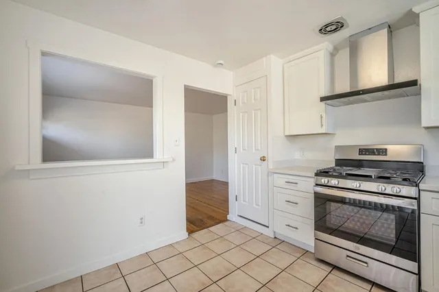 a kitchen with white cabinets and appliances
