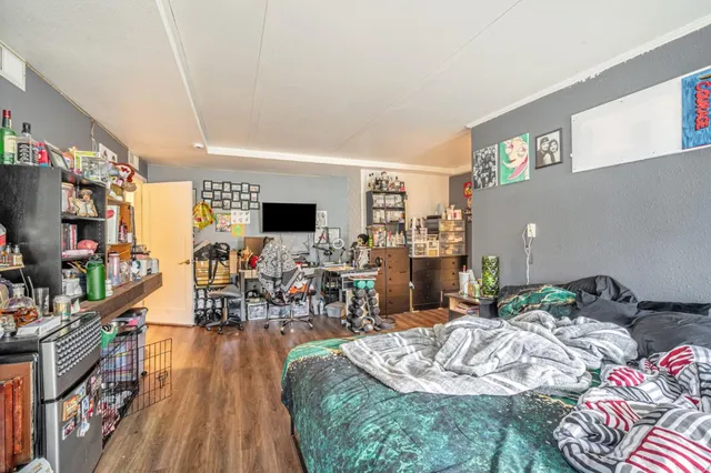 a bed room with a bed and a flat screen tv