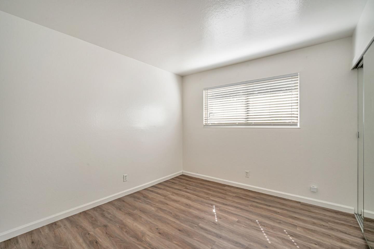 838 Wheeler Street Santa Rosa, CA 95404 - Photo 28 of 45 an empty room with wooden floor and windows