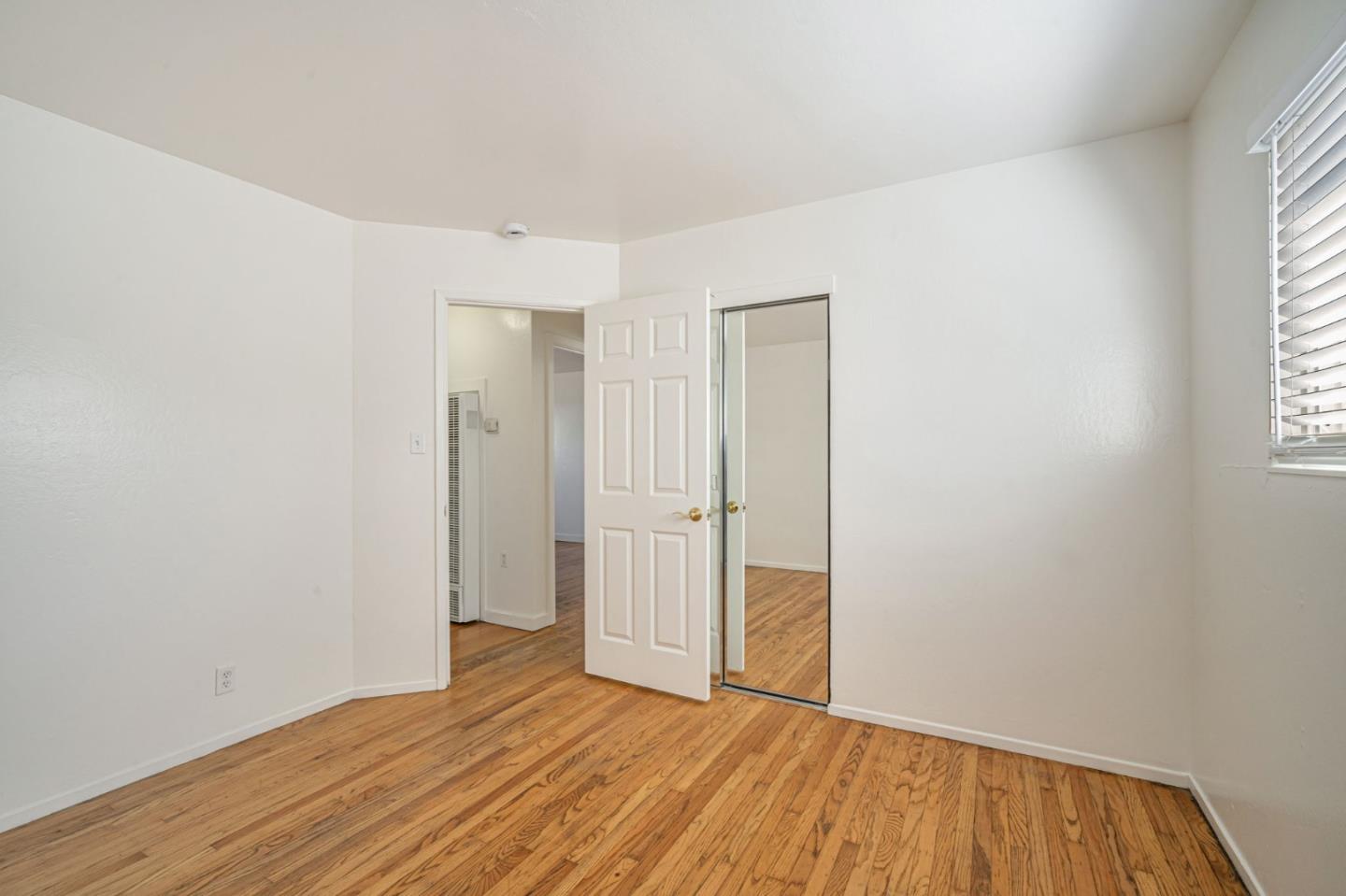 838 Wheeler Street Santa Rosa, CA 95404 - Photo 31 of 45 a view of an empty room with wooden floor and a window