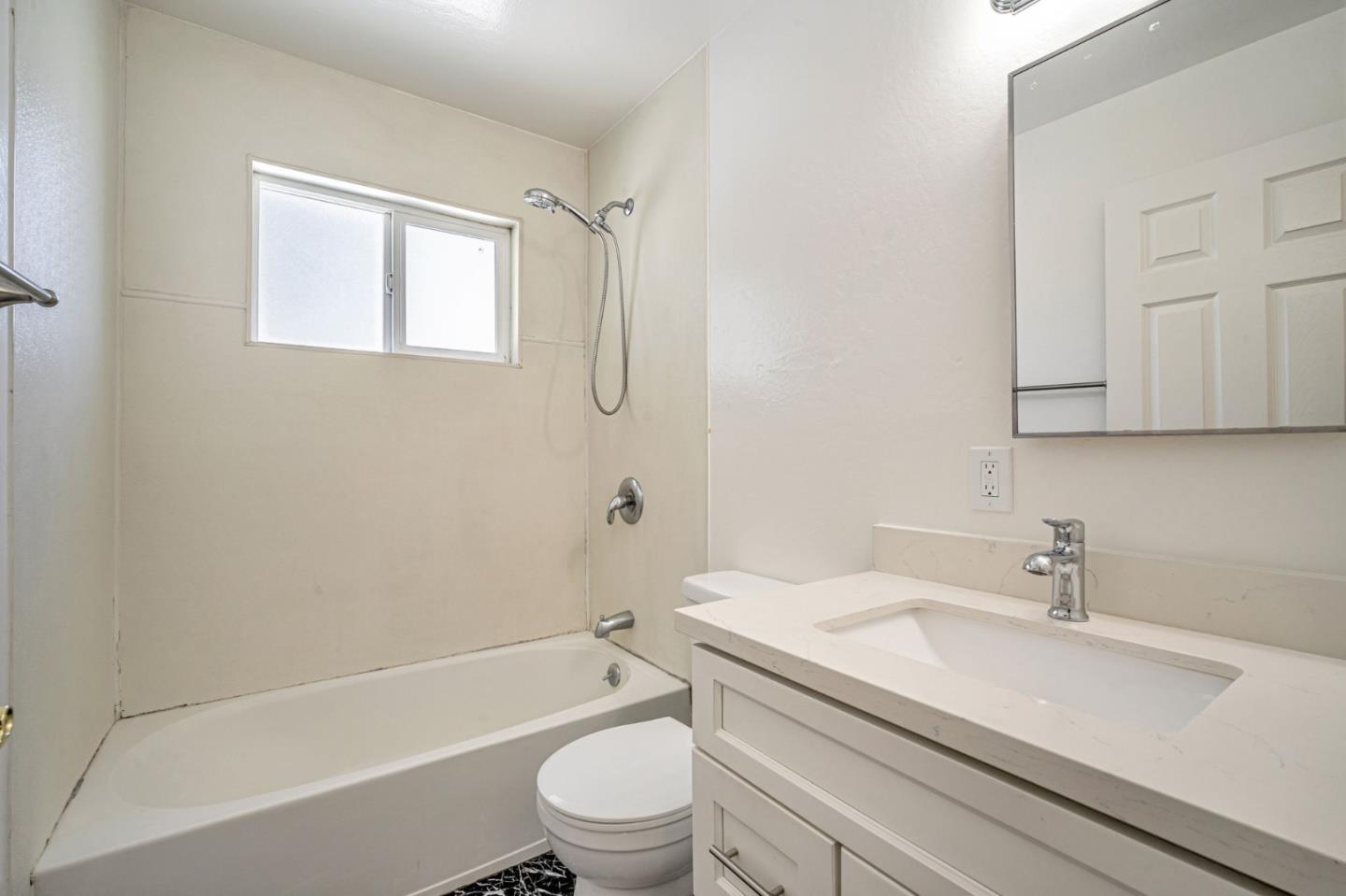 838 Wheeler Street Santa Rosa, CA 95404 - Photo 35 of 45 a bathroom with a granite countertop toilet a sink and a bathtub
