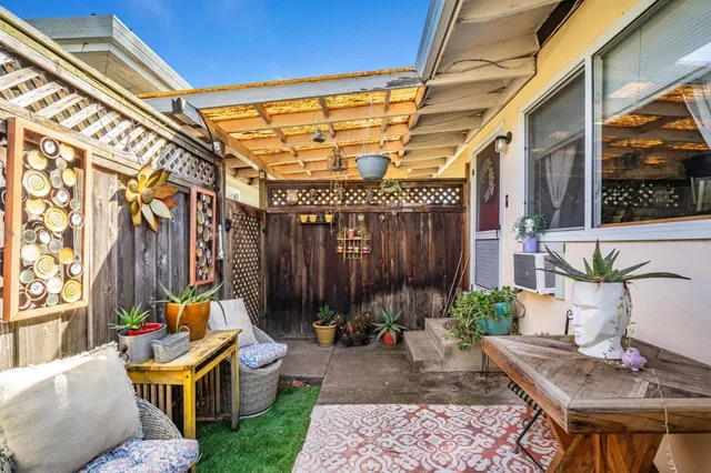 a backyard of a house with yard and outdoor seating