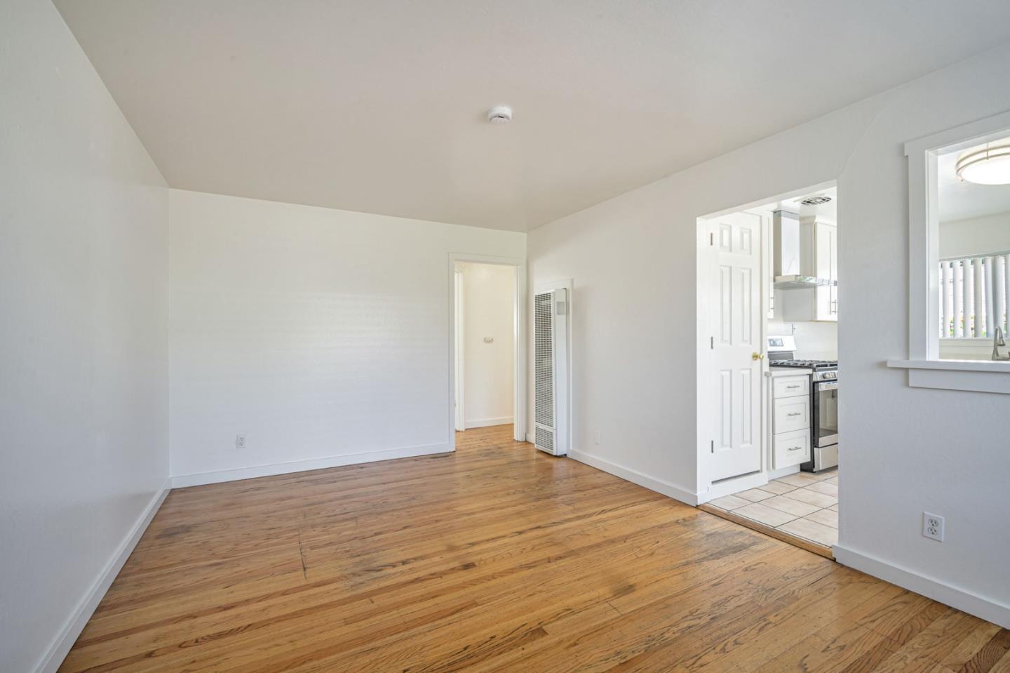 838 Wheeler Street Santa Rosa, CA 95404 - Photo 10 of 45 wooden floor in an empty room with a window