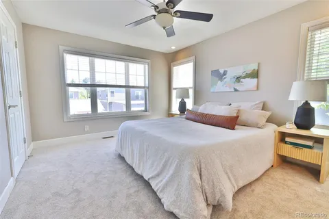 a spacious bedroom with a bed and window