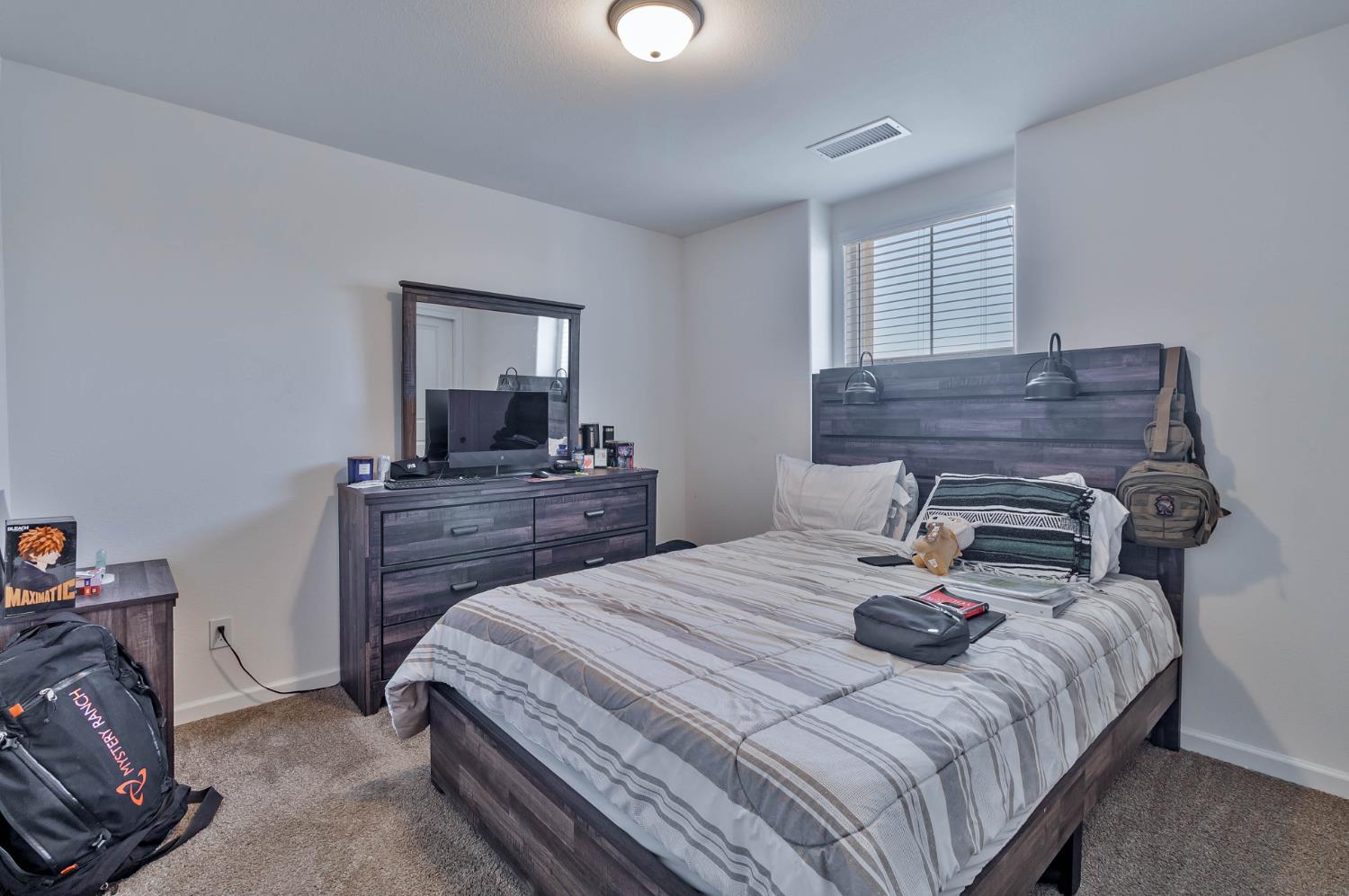 915 Winchell Way West Madera, CA 93636 - Photo 11 of 36 a bedroom with a bed and dresser