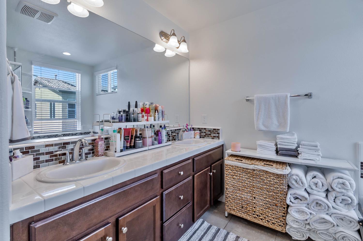 915 Winchell Way West Madera, CA 93636 - Photo 7 of 36 a bathroom with a sink double vanity and a mirror