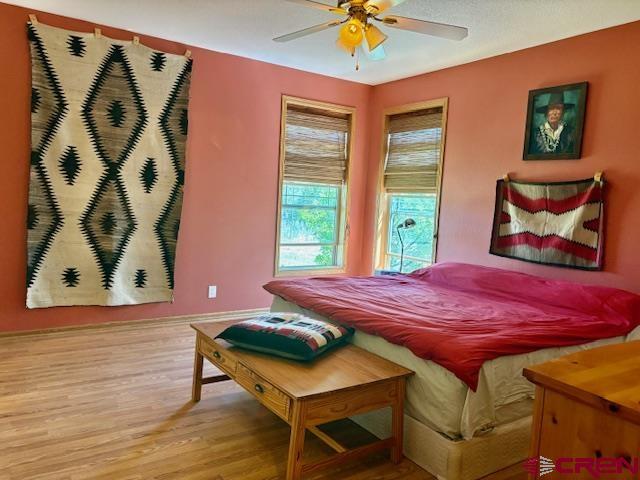 12299 Rd G Cortez, CO 81321 - Photo 19 of 44 a bedroom with a bed and painting on the wall