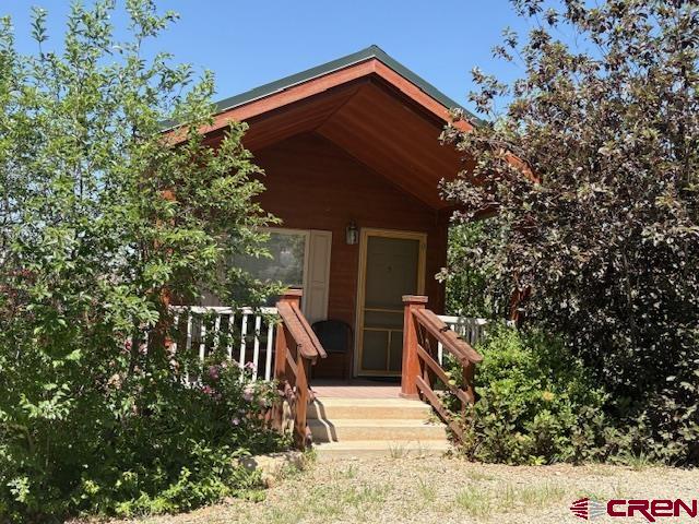 12299 Rd G Cortez, CO 81321 - Photo 26 of 44 a view of house with a yard and potted plants