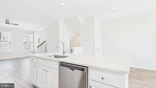 a view of a kitchen cabinets a sink and dishwasher in a white cabinet