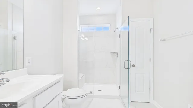 a bathroom with a shower a toilet and a sink