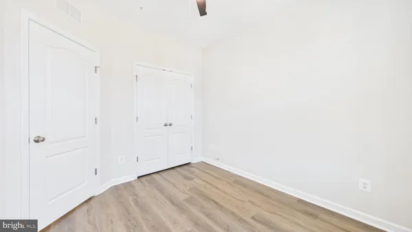 a view of a room with wooden floor