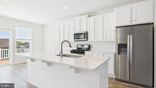 a kitchen with stainless steel appliances a refrigerator sink and cabinets