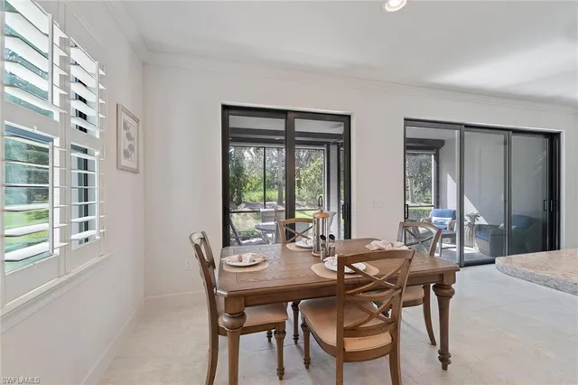 a view of a dining room with furniture and window