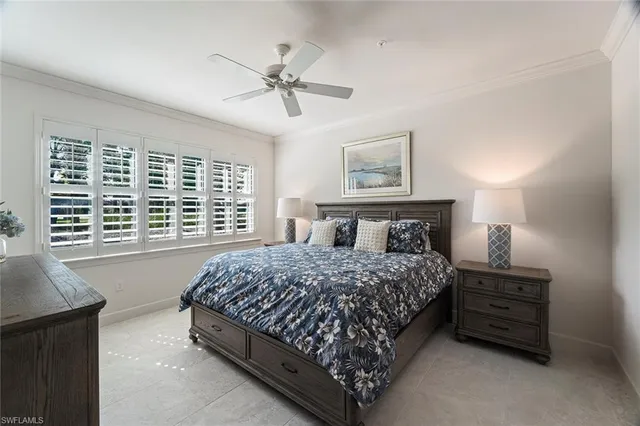 a bedroom with a bed a dresser and a window