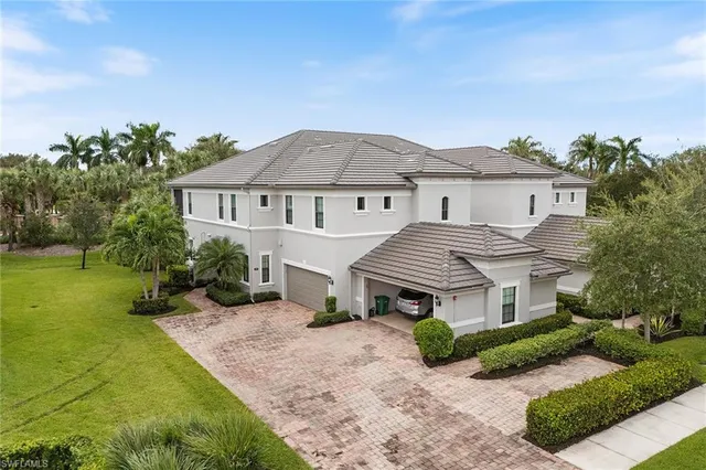 a front view of a house with a garden and plants