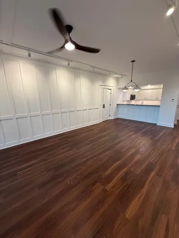 a view of a room with wooden floor